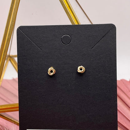 Gold earrings on a black card with Ever Jewelry Co. branding against a pink and gold geometric background.